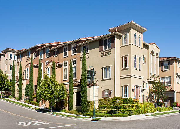 Modern town homes with street corner A modern multi-story townhome development with surrounding vegetation, in San Jose, California. italian cypress stock pictures, royalty-free photos & images