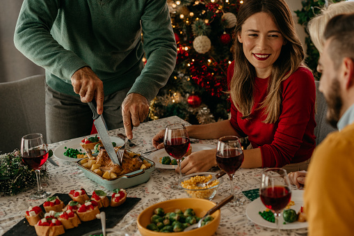 The magic of Christmas is palpable as a family of all ages comes together for a delicious holiday meal, spreading cheer and joy.