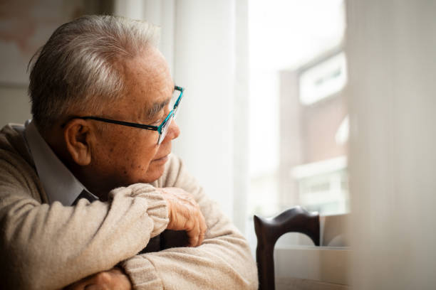 istock An elderly man sadly looking out the window. Melancholy and depressed. 1509293048