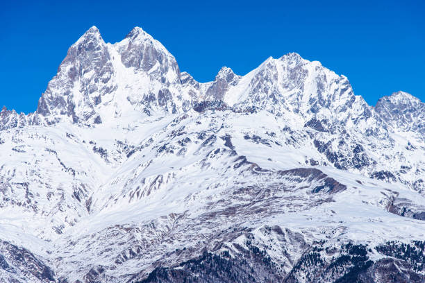 istock Beautiful panoramic view Ushba peak in Caucasus mountains covered with snow in winter and blue sky in Mestia Svaneti Georgia 1509298922