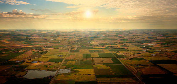 Sunrise on Horizon, aerial view of South Dakota Farm land. Illustrated sunrise over an aerial view of South Dakota farm land - August 2012  4,000 feet AGL. south dakota stock pictures, royalty-free photos & images