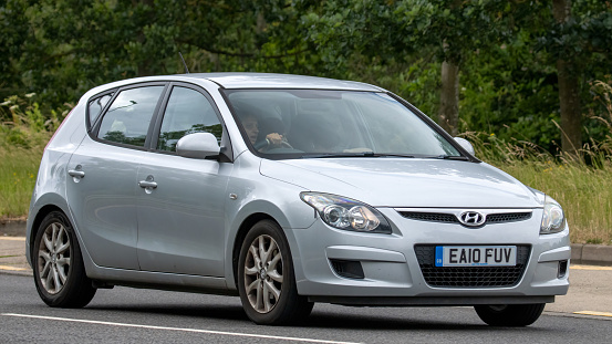 Milton Keynes,UK - July 2nd 2023.  2010 silver diesel HYUNDAI I30  car travelling on an English country road