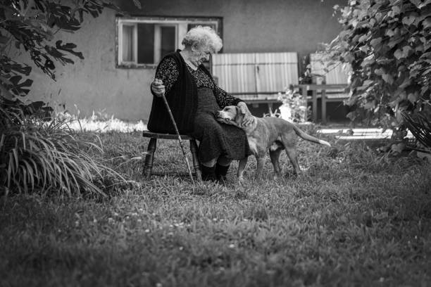 Elderly woman coping with the aging process by being accompanied by her dog friend