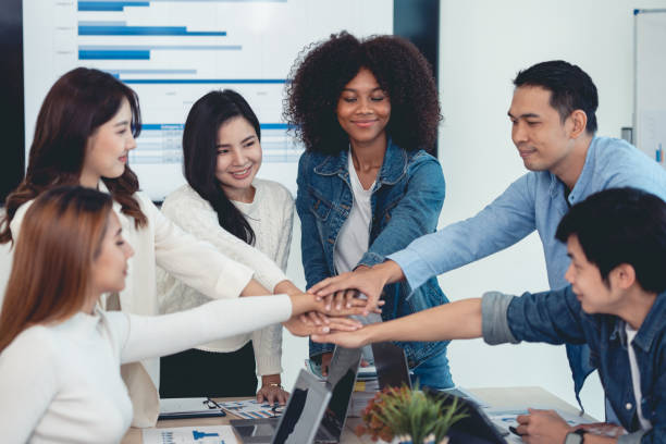 istock Young Asian business people shaking hands and working together as a team and having unity in working on new start-up project. Unity and Teamwork Concept. 1509361140