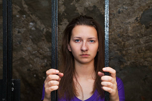 istock Young woman behind the bars 150938438