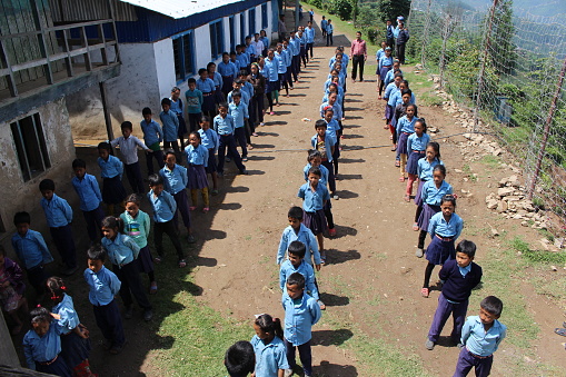 Students in school uniform racing across outdoor recreation area