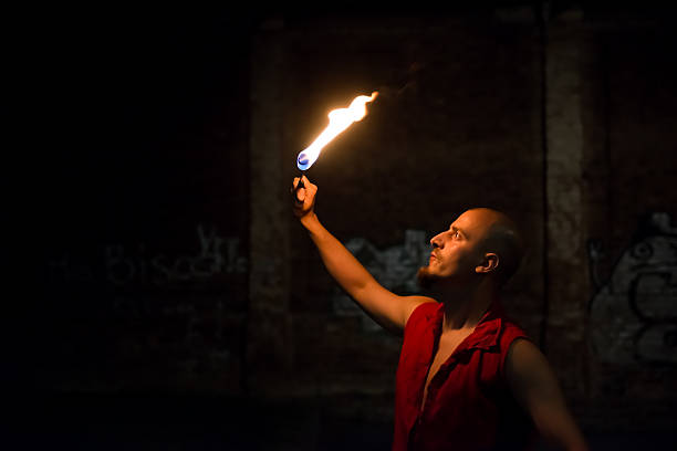 istock Street Performer Fire Breather Blowing on Torch 150942497