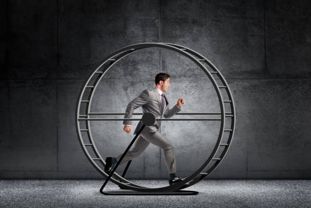 Businessman Running In Circles On A Treadmill stock photo