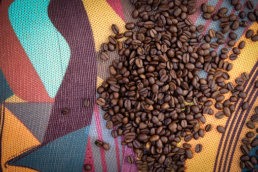 Coffee beans. Colorful tablecloth. Top View. Copy space.