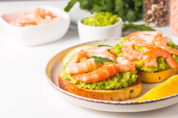 istock Shrimps on toast with avocado and lemon. Breakfast concept. Bruschetta. 1509483781