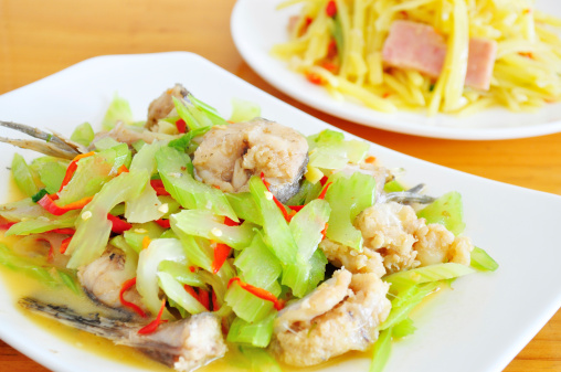 chinese food:cooked fish with celery in white plate