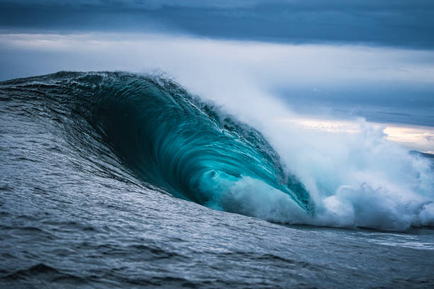 istock Close up of powerful ocean wave breaking over shallow reef with stormy sky 1509512280