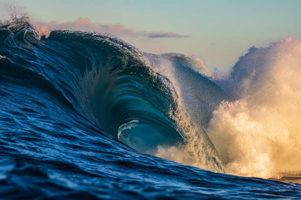 istock Bright blue abstract ocean wave breaking over shallow reef in golden morning light 1509513861