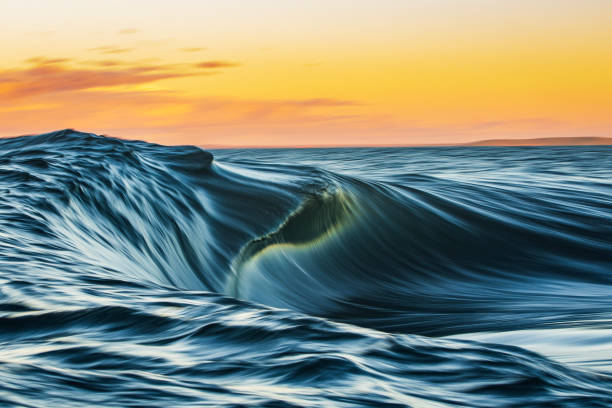 istock Abstract motion blur of smooth ocean wave breaking over shallow reef in golden light 1509514378