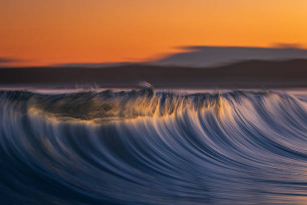 istock Abstract motion blur of smooth ocean wave breaking in golden light 1509516508