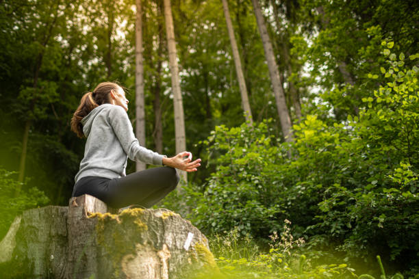 istock Woman meditating in the forest. 1509522085