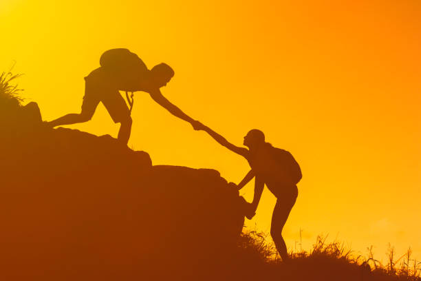 istock Men helping his hiker friend. 1509524886