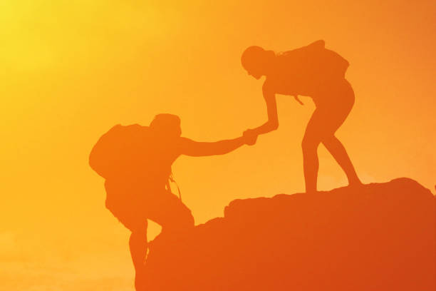 istock Hiker helping her friend at hiking. 1509526325