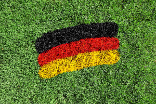 Close up of German flag colors black, yellow and red painted on grass field