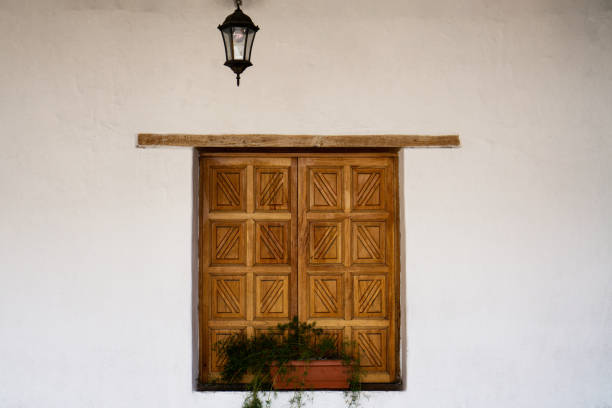 istock Wood shutter window with decorative pattern. Potted plant on the windowsill 1509538185