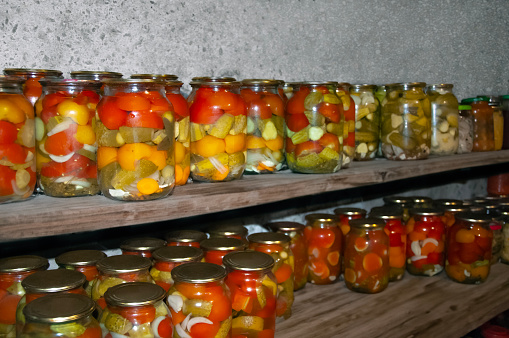Jars of a variety of pickled vegetables . Canned foods. Preserves