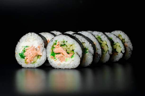 istock Rolls with tuna, cream cheese, cucumber, rice and nori, isolated on black 1509554837