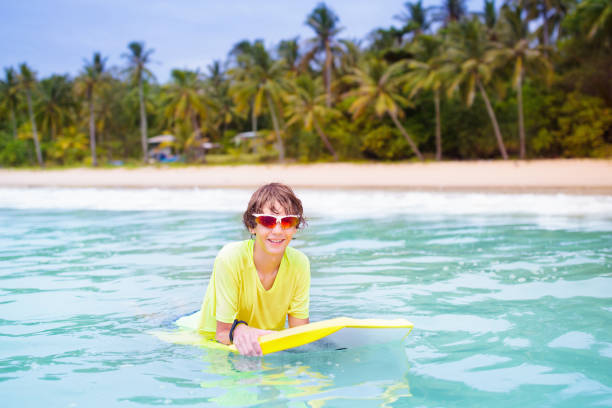 istock Surfer on tropical beach. Boy surfing. 1509557489