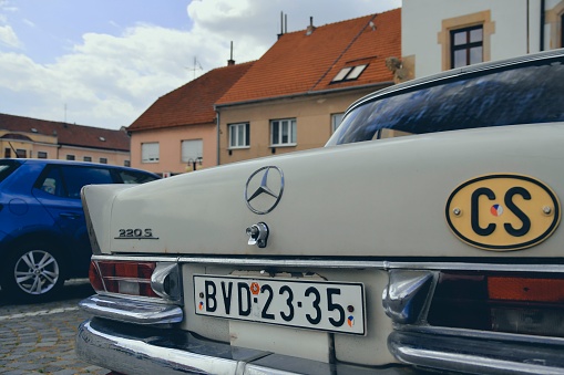 Hustopece, Czechia - July 1, 2023: Mercedes Benz logo on a vintage car. Mercedes-Benz 220 S. Mercedes-Benz is a German automobile manufacturer. The brand is used for luxury automobiles, buses, coaches.