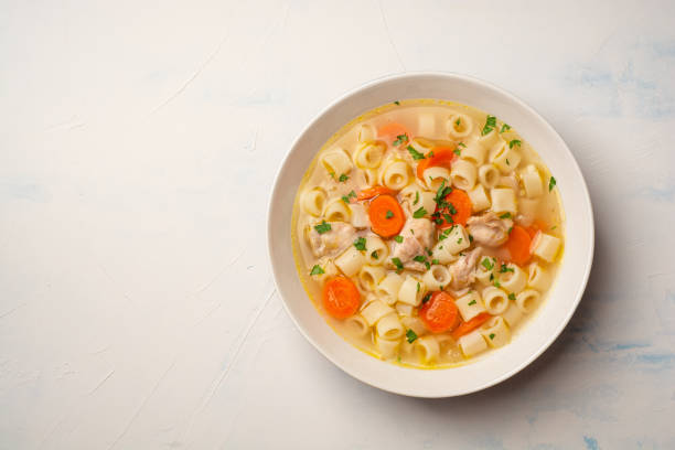 istock Chicken soup with pasta in plate on concrete background 1509591555
