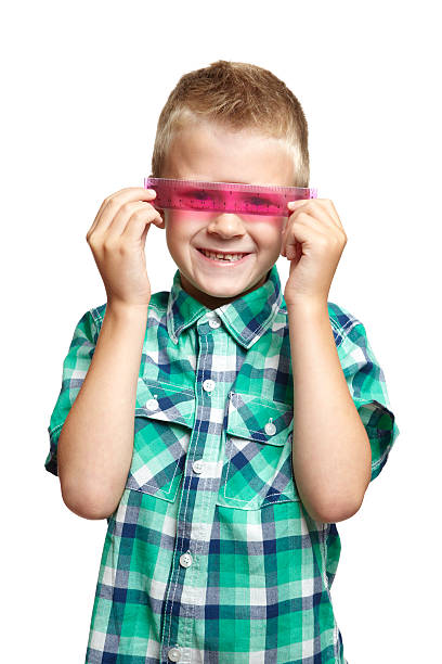 istock 8 year old school boy with pink ruler 150961860