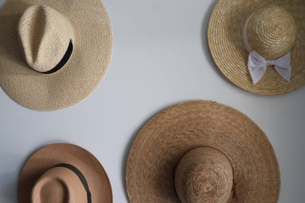 istock Four straw hats hanging on a white wall 1509660705