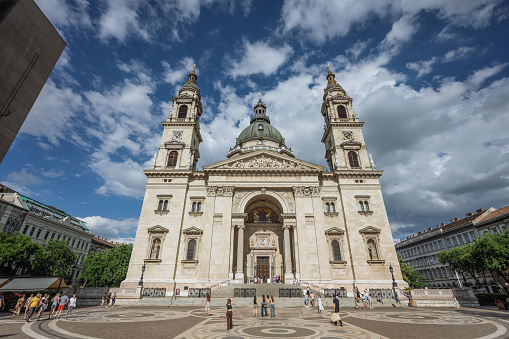 Budapest, Hungary - July 11, 2012: Tourists in front of St. Stephen's Basilica in Budapest, Hungary. It is the third largest church building in present-day Hungary.