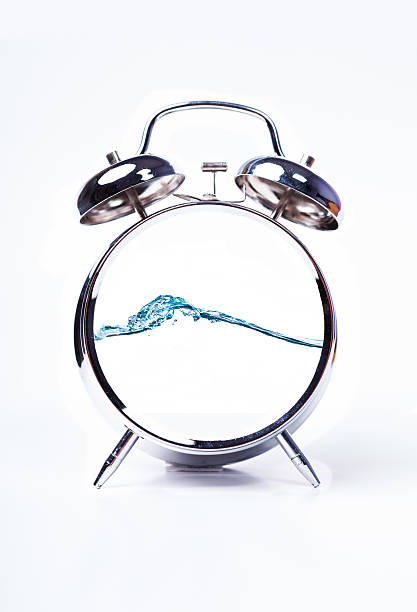 alarm clock with water waves stock photo
