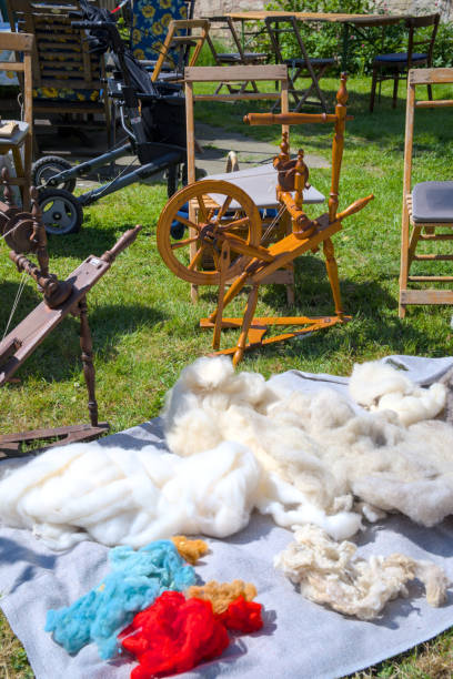 istock Spinning wheel and equipment on the open air. Yarn, wool, thread. 1509714638