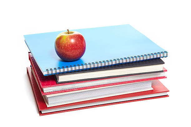 istock School books and apple on white background 150971486