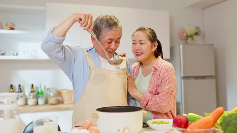 Asian elderly couple in kitchen