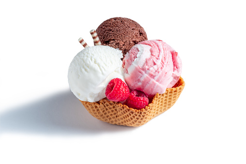 Three scoops of ice cream: white, brown and pink in a waffle glass on a white background.