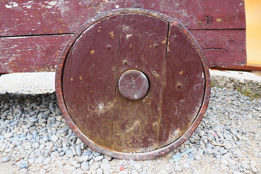 Medieval wooden wheel from a cast-iron cannon. Herceg Novi, Montenegro. Naval artillery, artillery gun. Ancient chariot wheels and cannons made of wood