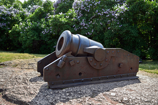 Medieval metal cannon as a monument in the park