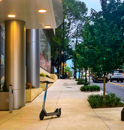 Midtown Atlanta sidewalk with an abandoned electric scooter