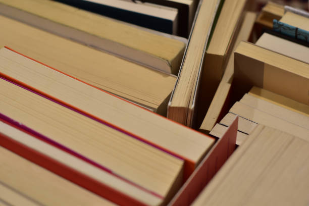 istock reading concept: stack of old books with paper turned up 1509799043