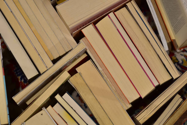 reading concept: stack of old books with paper turned up