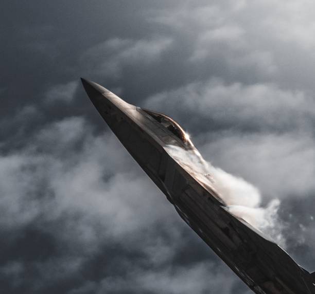 istock Airplane soaring through the sky with a white cloud of smoke trailing from its front 1509809125