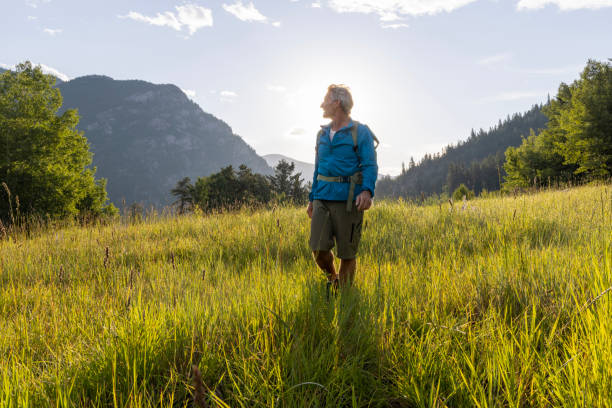 istock Senior hiker explores mountain meadow 1509835641