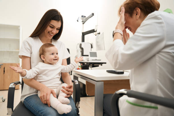 istock Baby sitting on mother lap in ophthalmologist office 1509855231