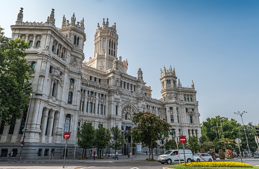Madrid, Spain - June 28, 2023: View of the Cibeles Palace (Palacio de Cibeles), formally known as Palace of Communications until 2011, is a complex made up of two buildings with white facades and is located in one of the historic centers from Madrid, Spain. Now is occupied by Madrid City Council, serving as the city hall, and the public cultural centre CentroCentro.