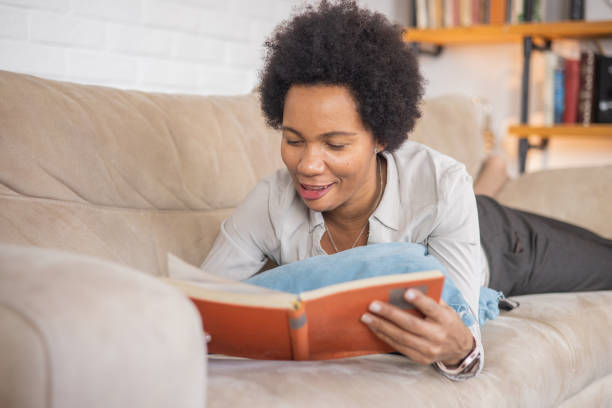 istock Woman reading book at home 1509985809