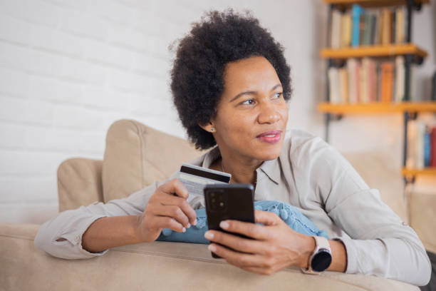 istock Cheerful  woman doing online shopping 1509986888