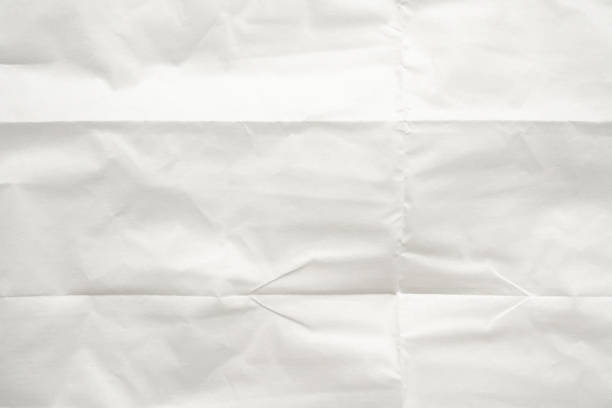 istock White folded and wrinkled paper texture background 1509988615