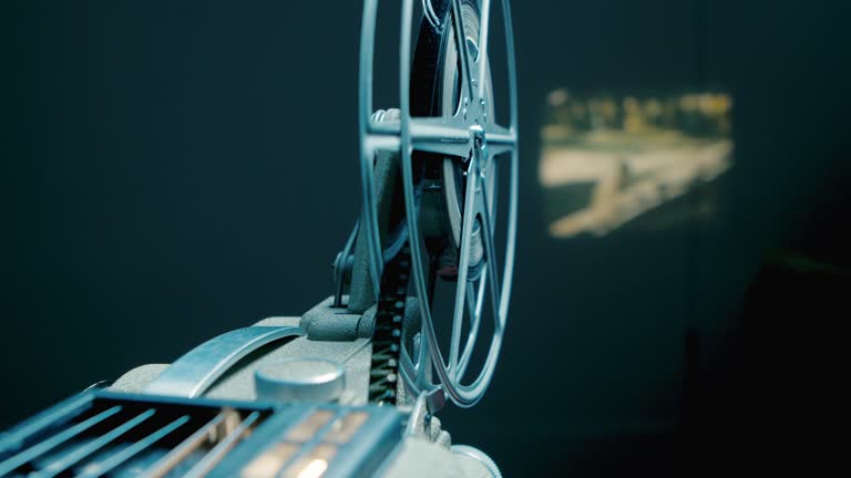 Close-up of film reels spinning in an old movie projector.